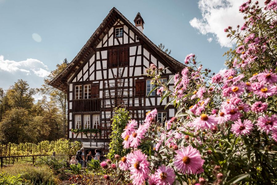 Haus mit blühenden Blumen im Garten im Freilichtmuseum Ballenberg